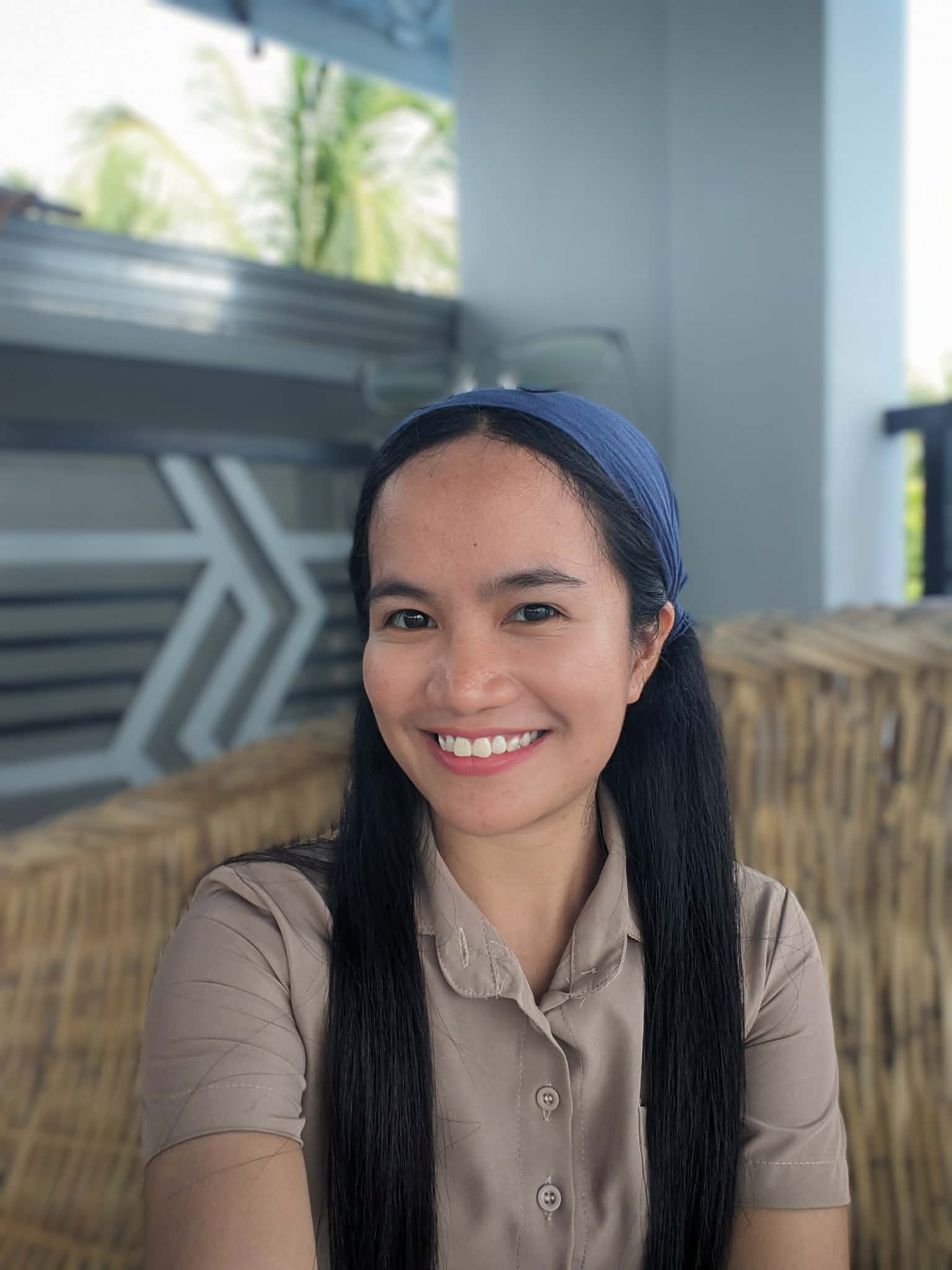 Portrait of Karylle Paed, YouTube script writer, smiling in warm natural light.